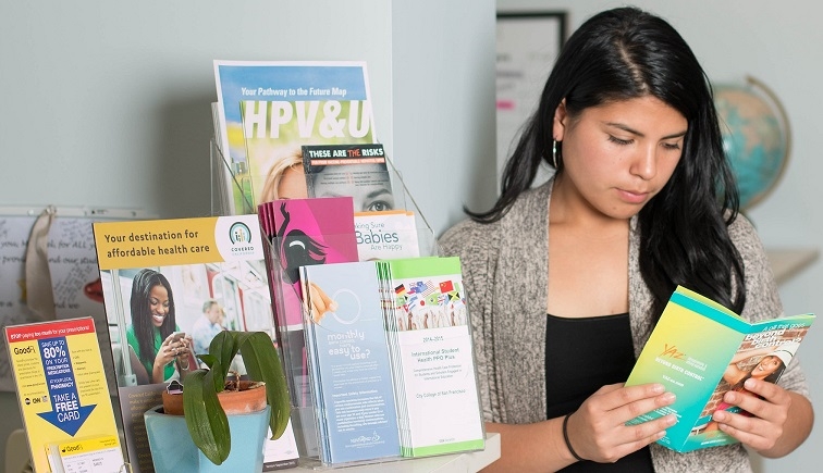 Patient looking at birth control education materials. 