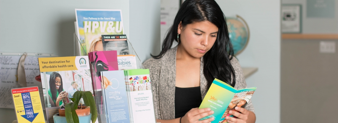 Patient looks at educational material on birth control
