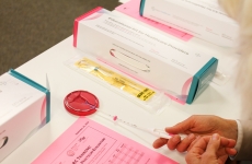 Provider practices inserting an IUD into a plastic demo model. 