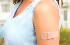 Photo of a person with a band-aid on their arm 