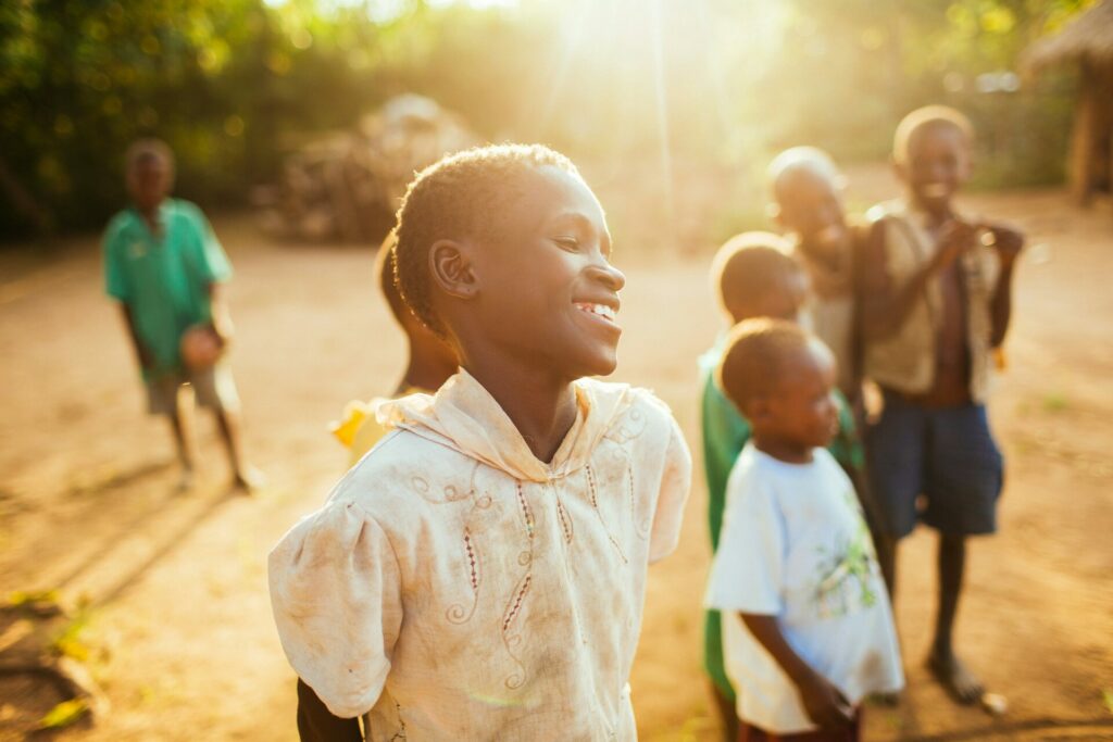 Young woman from Uganda in her village at sunset